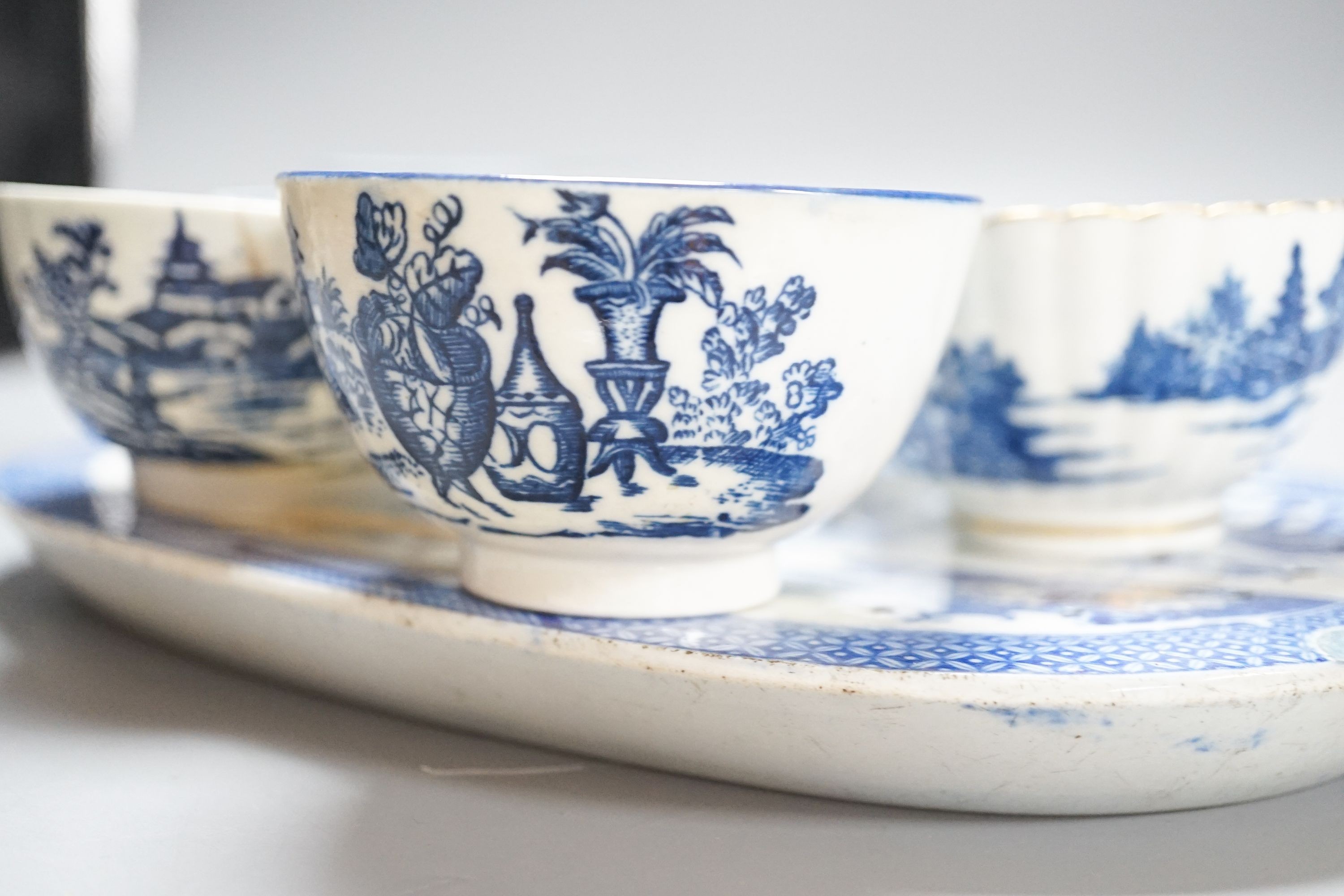 A group of Worcester and Caughley blue and white tea and coffee wares, late 18th century including fisherman pattern, three flowers pattern, chinoiserie figures etc.